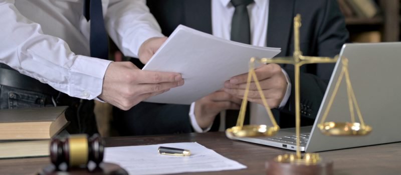 Close,Up,Shoot,Of,Advocate,Working,With,Assistant